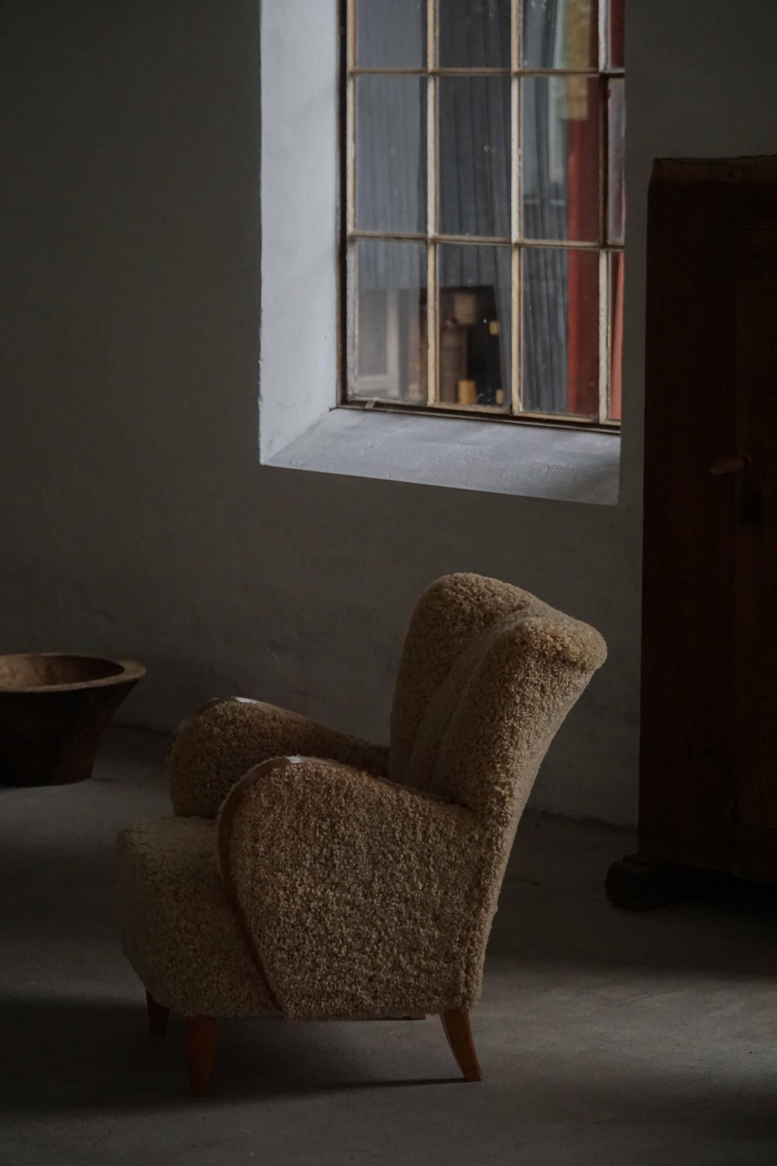 Pair of Danish Art Deco modern lounge chairs in sheepskin with lambswool and elm, 1940s.