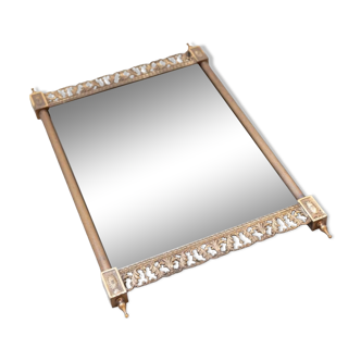 Brass wall mirror with carved and pierced profiles at top and bottom, mid century.