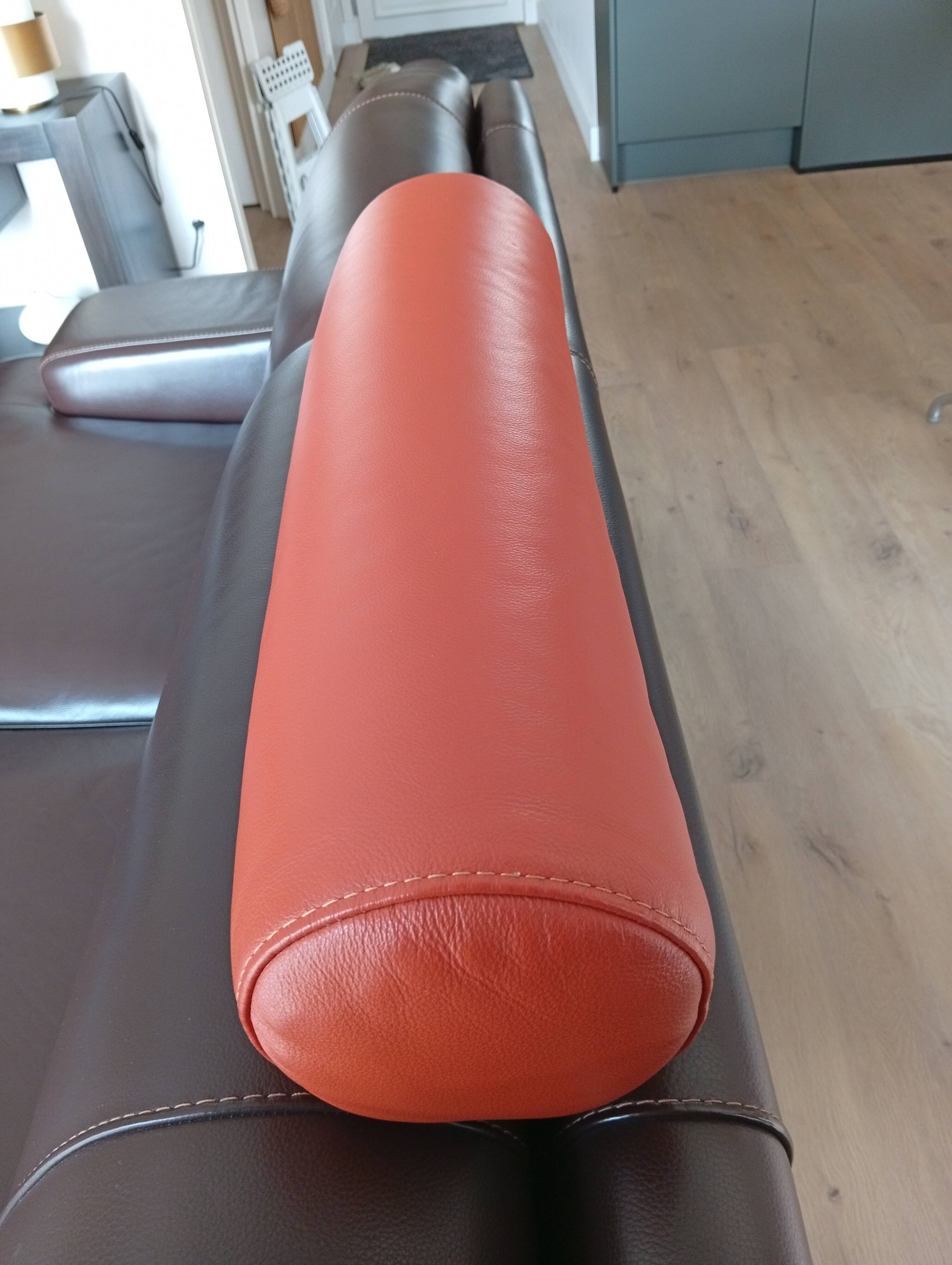 Two brown leather Crozatier two-and-a-half-seater sofas.