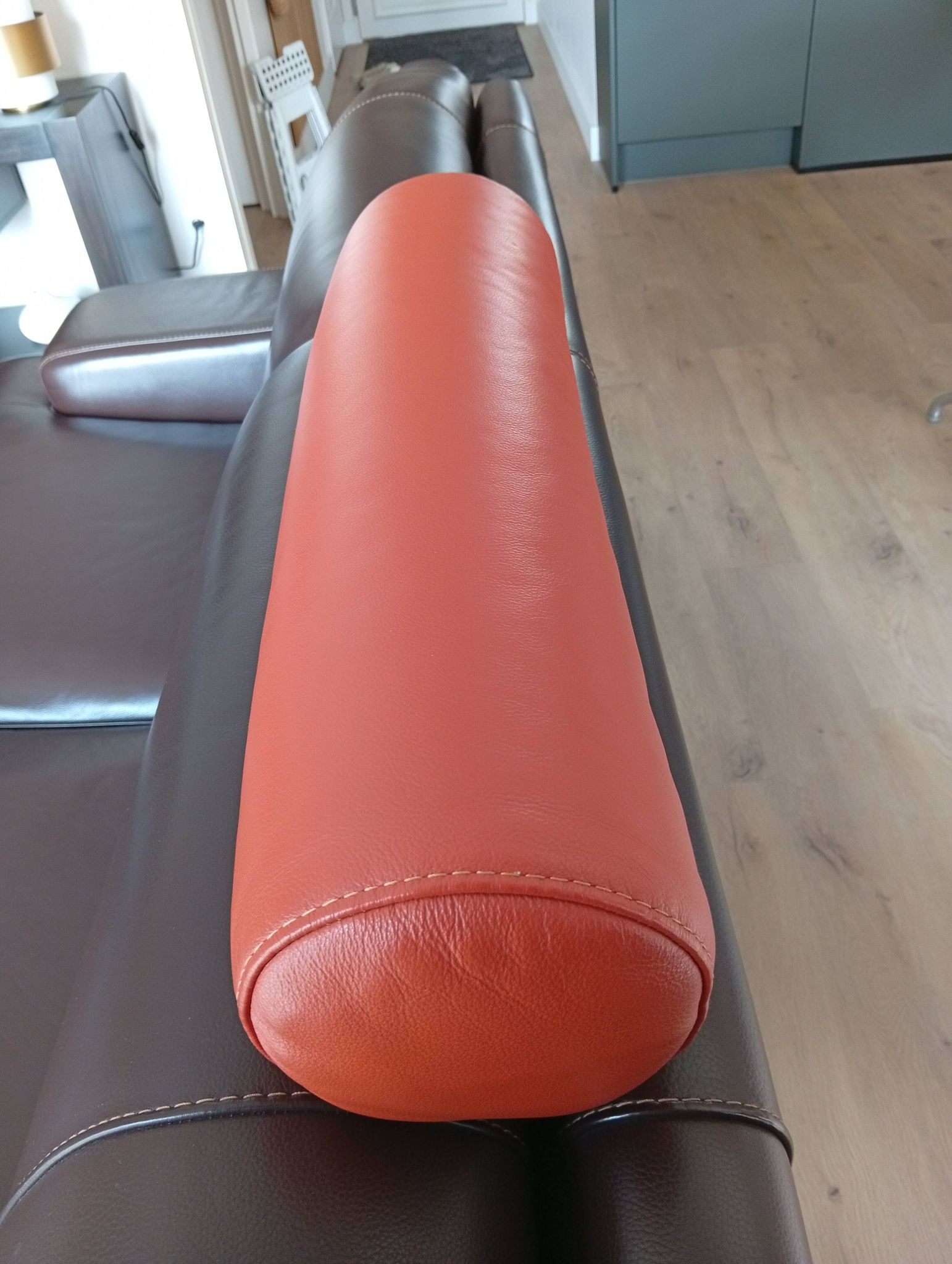 Two brown leather Crozatier two-and-a-half-seater sofas.