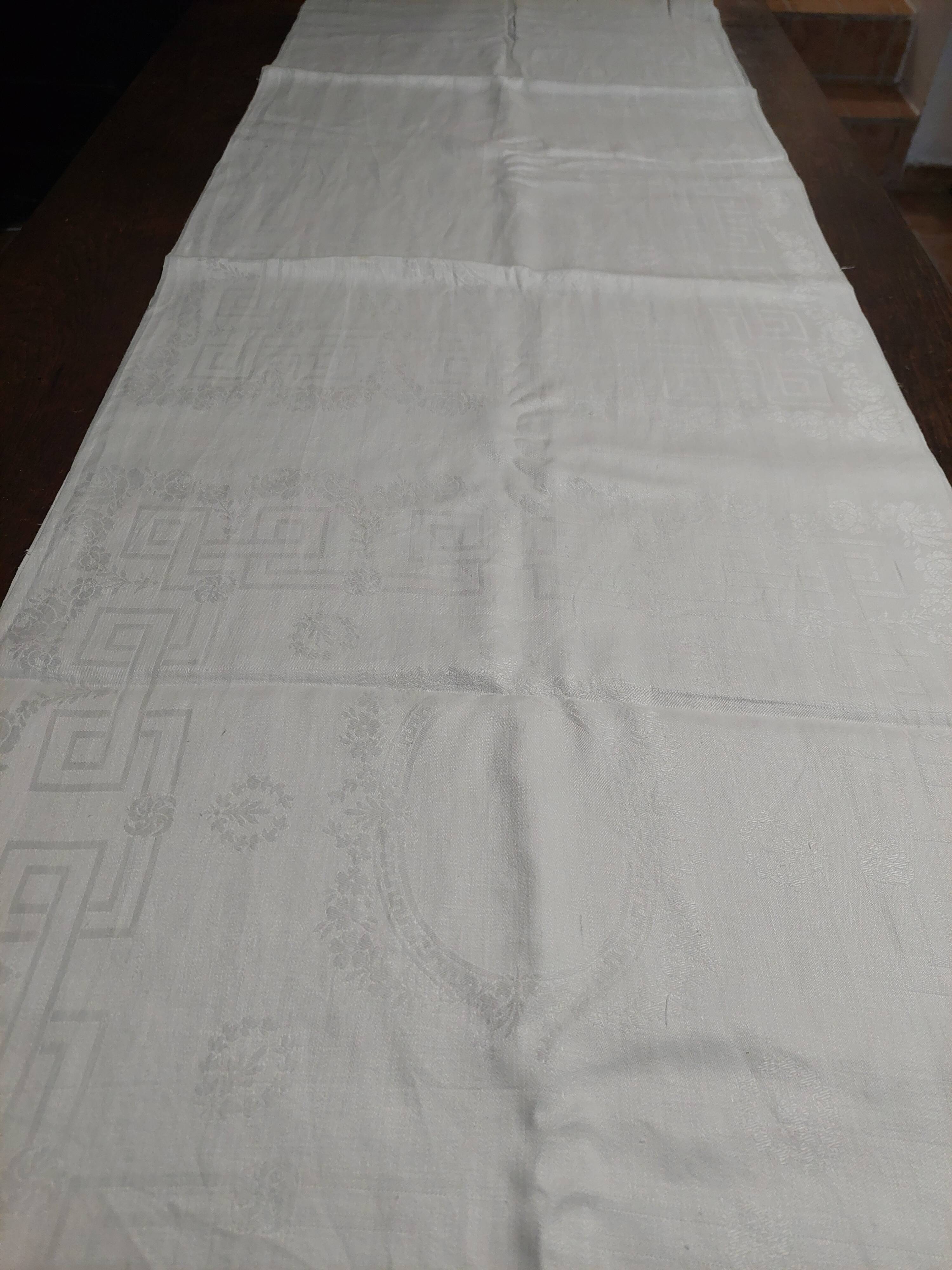 Table napkins set of eleven in a single piece damask linen and silk early 20th century.