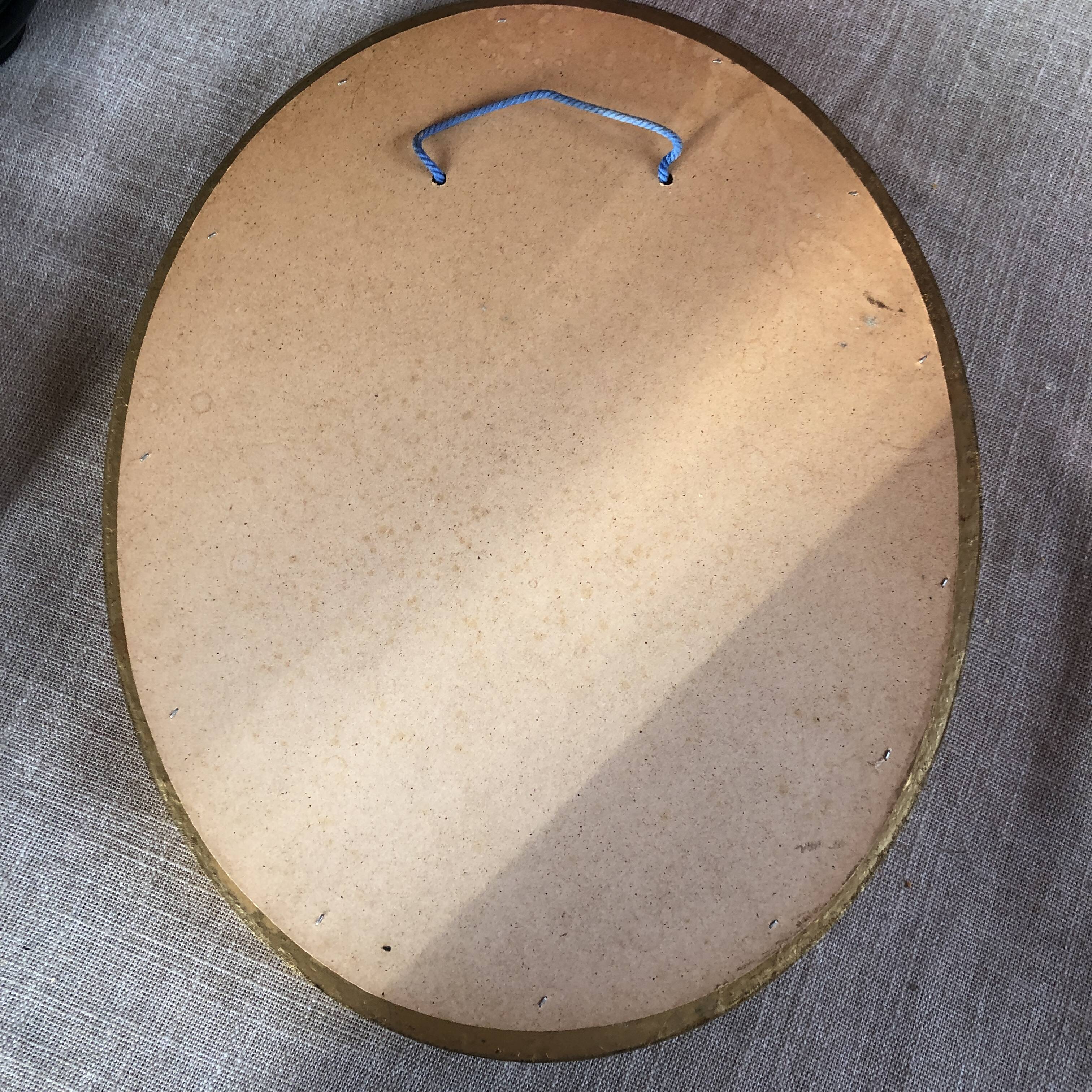 Golden oval mirror