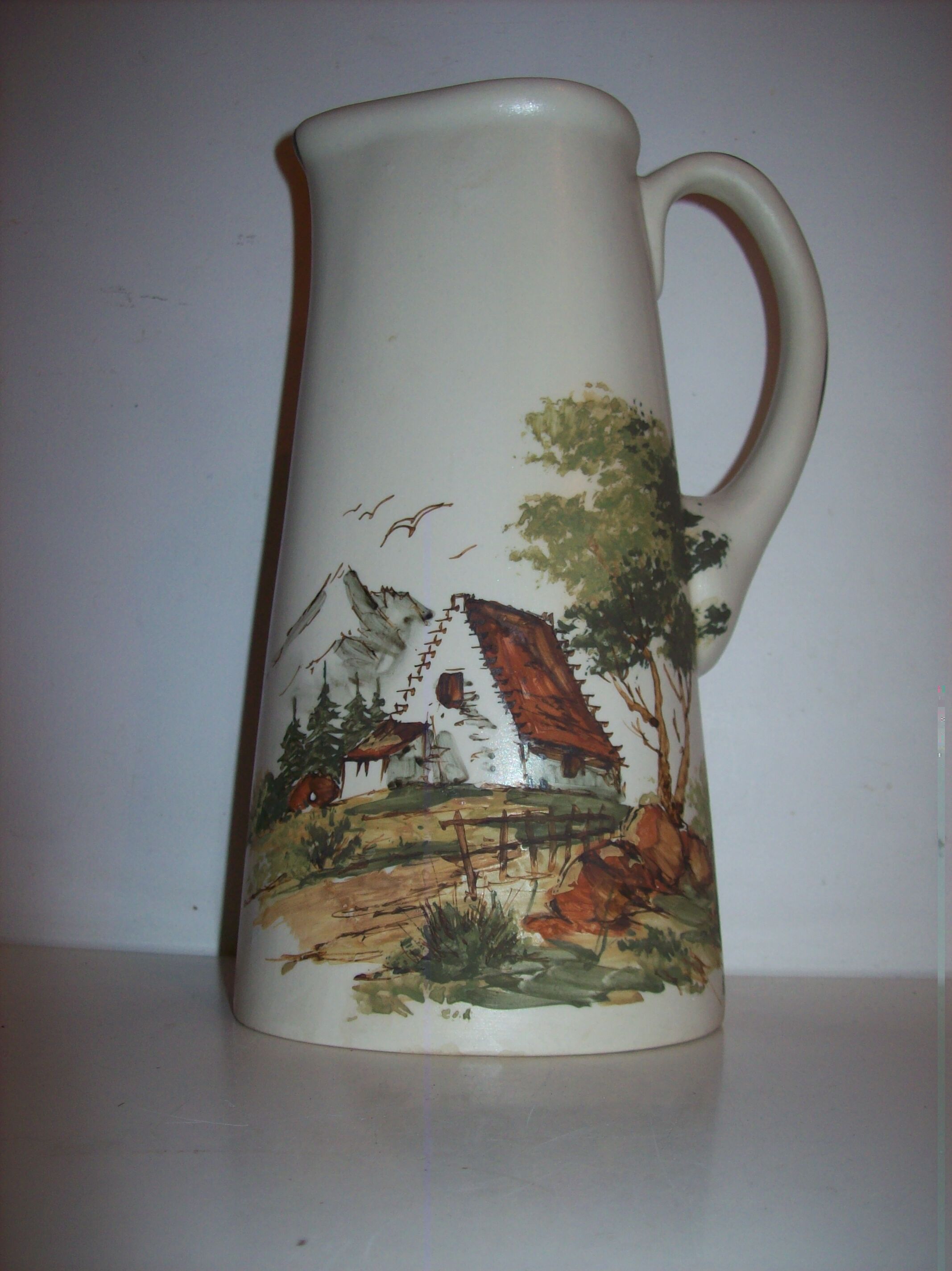 Ceramic pitcher with hand-painted decoration