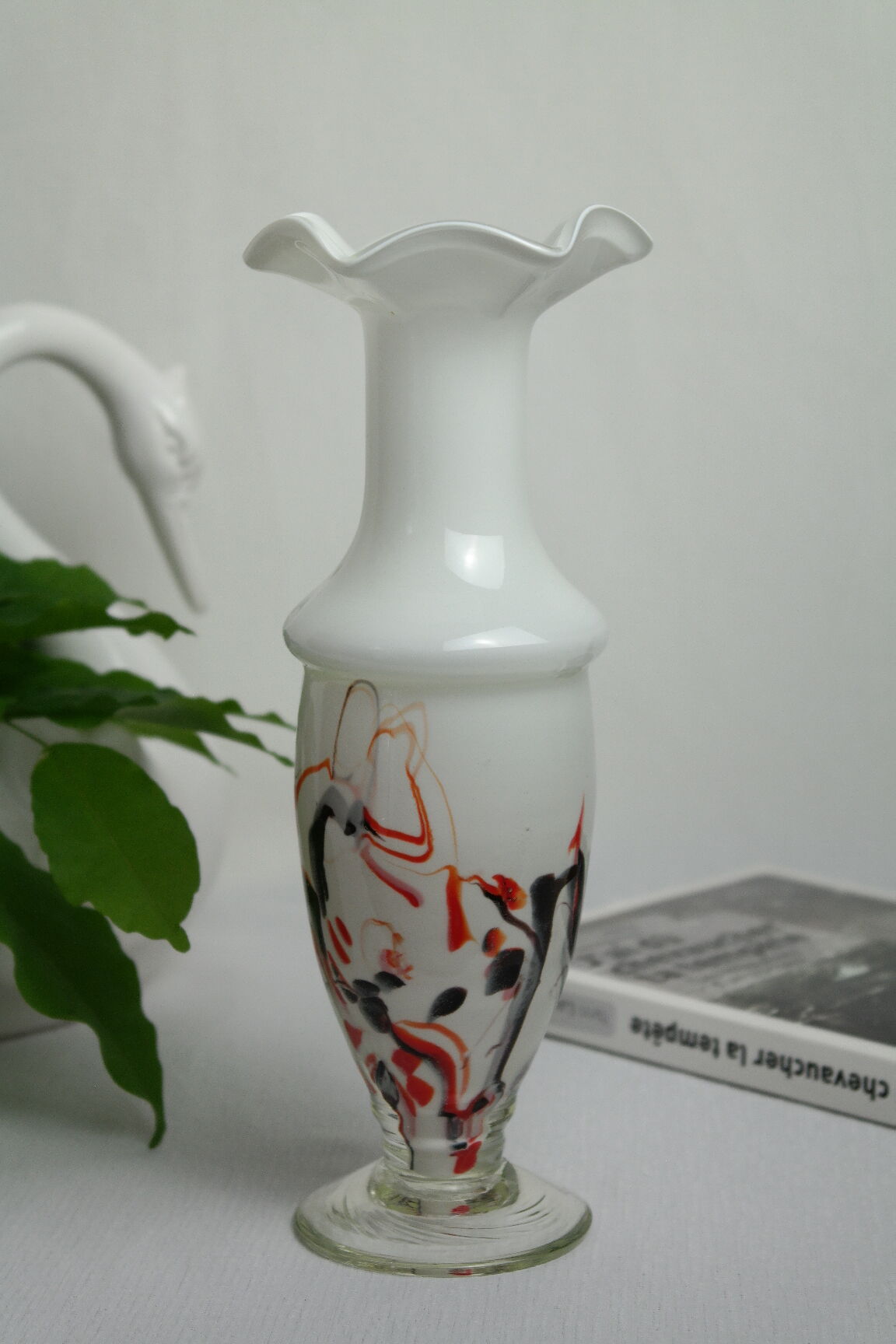Corolla vase in white opaline with orange-brown patterns.
