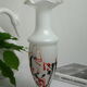 Corolla vase in white opaline with orange-brown patterns.