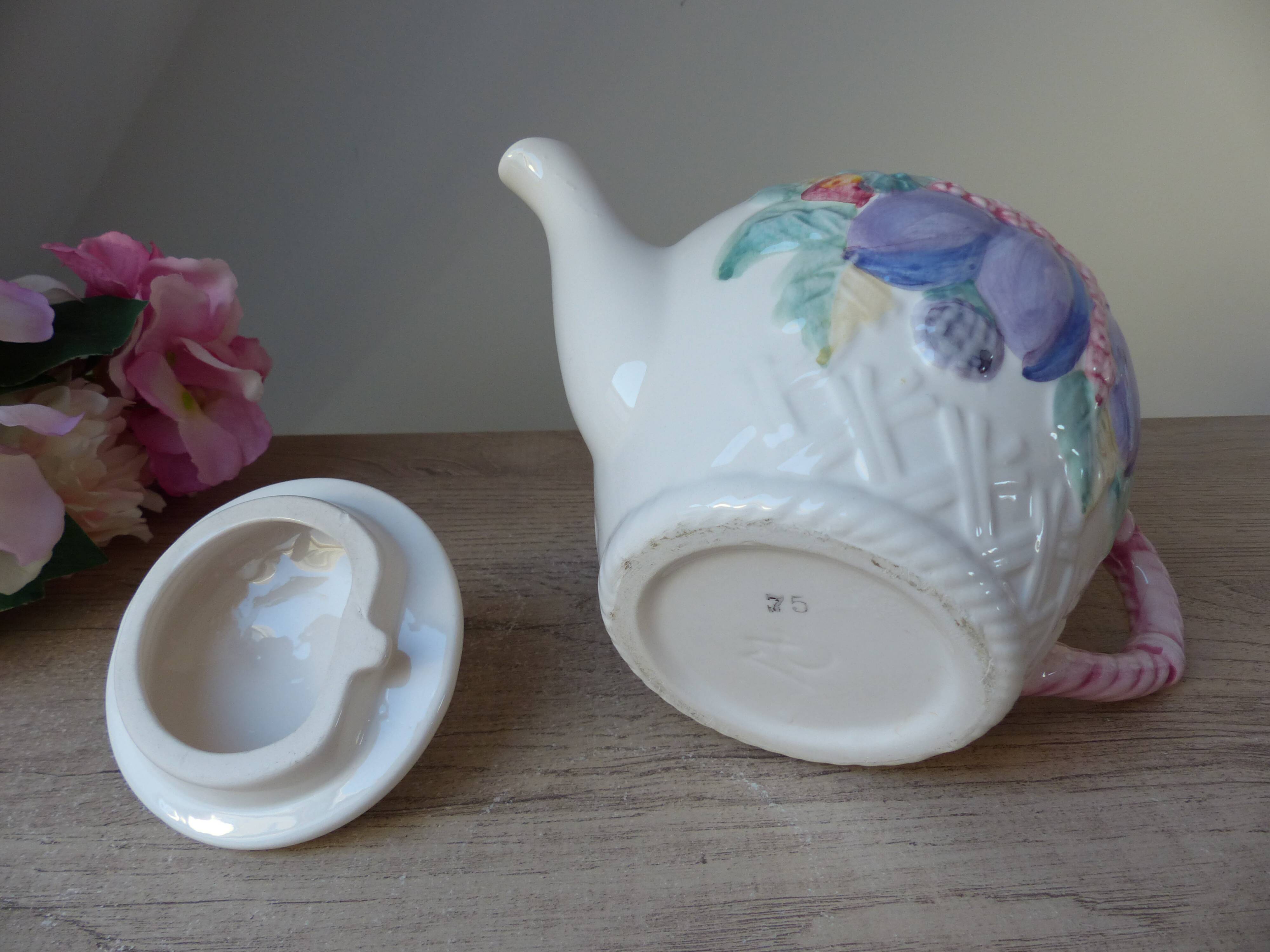 Old ceramic teapot in the shape of a basket of fruits from the garden