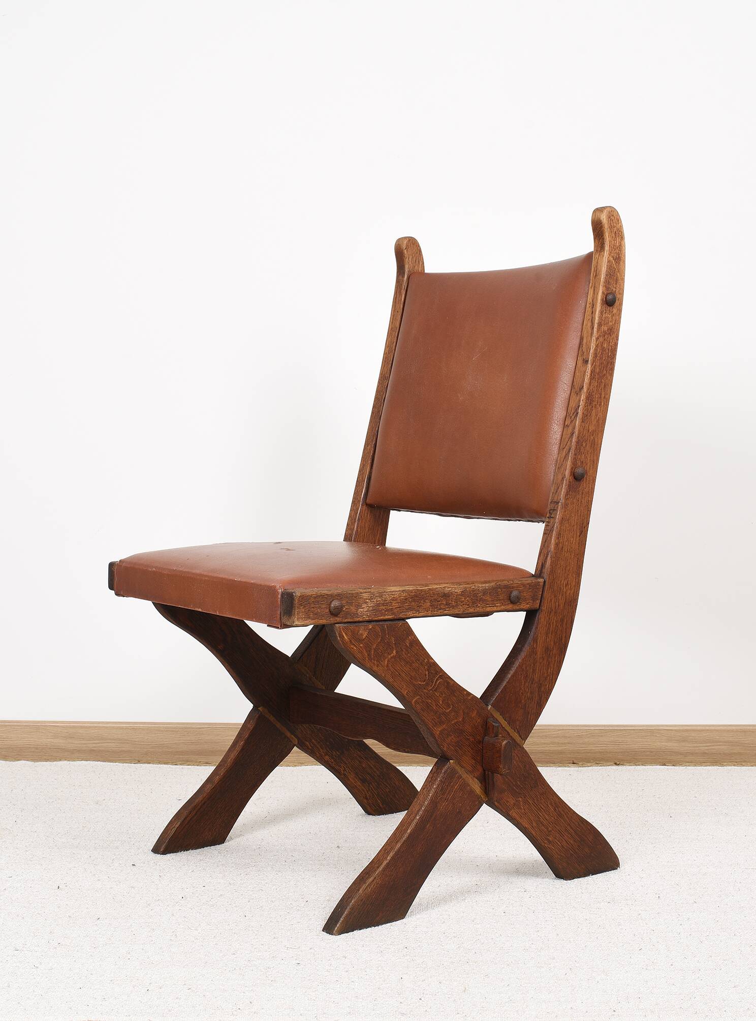 Pair of brutalist style chairs, in wood and leather.