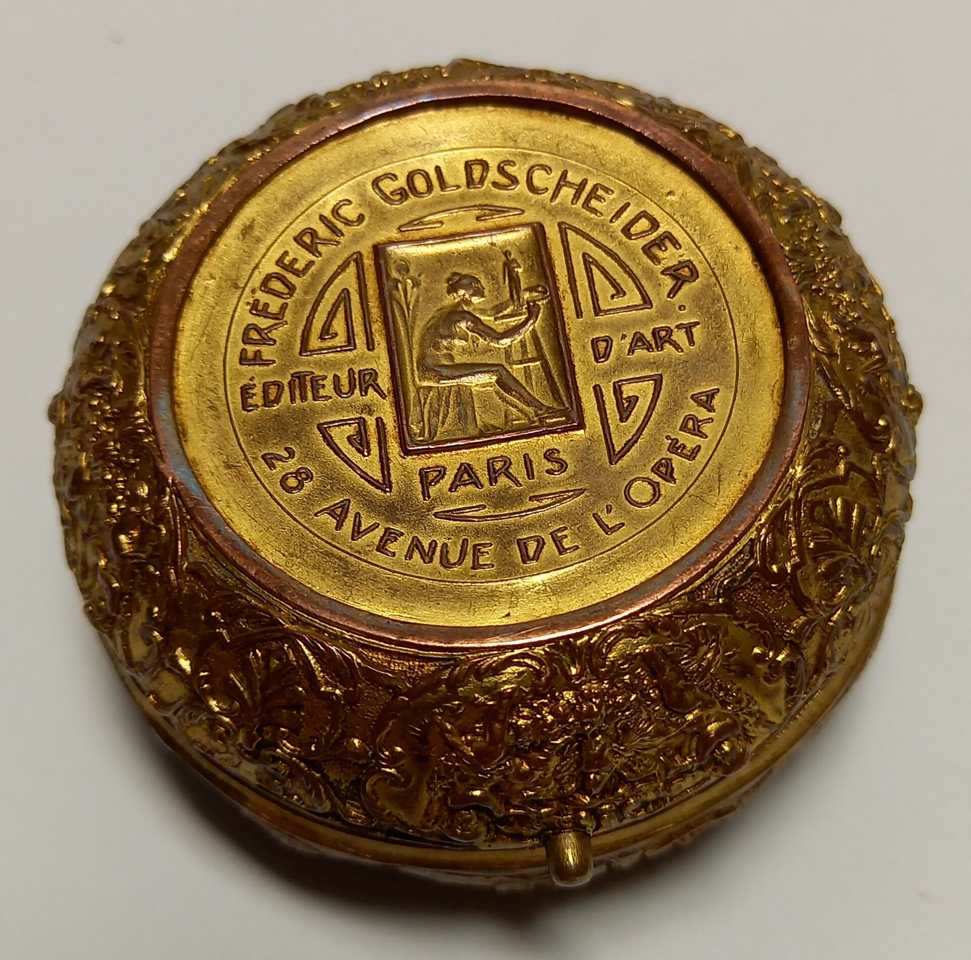 Old brass and copper powder magazine decorated with cherubs