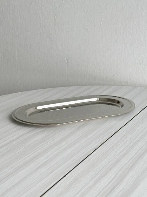 Small antique tray made of lightweight metal.