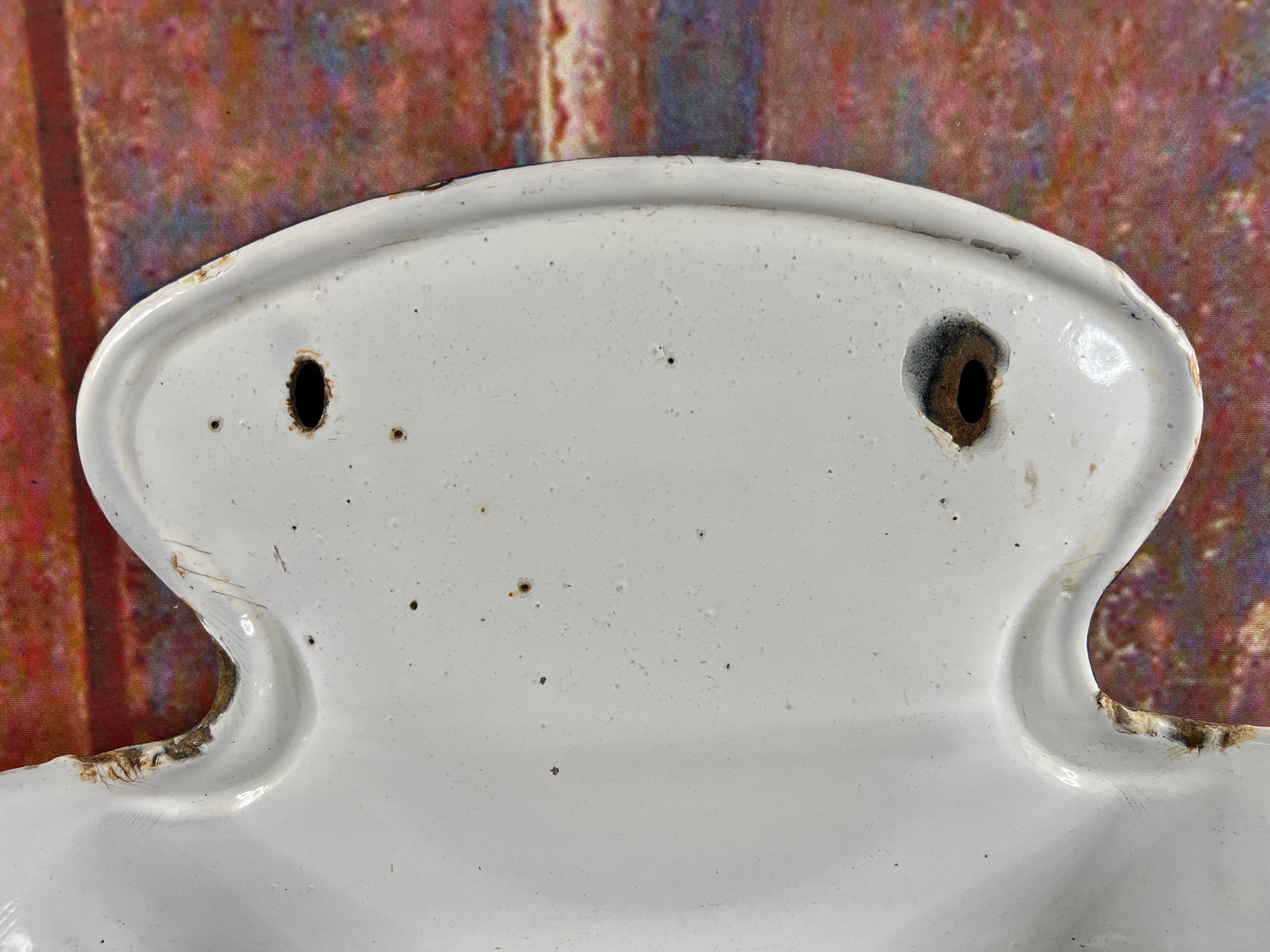 Old white enamelled hand washbasin or gardener enamel garden