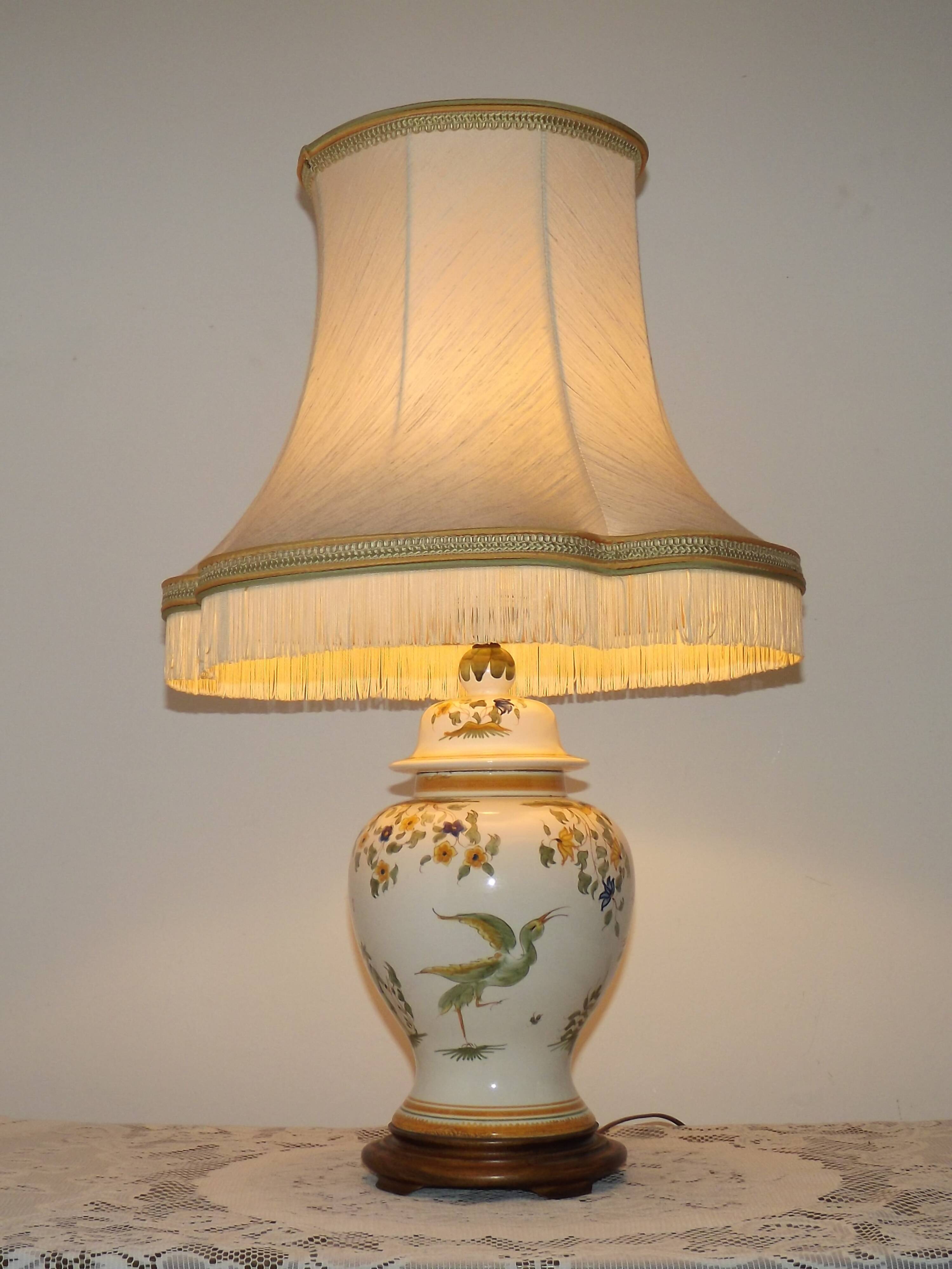 Table lamp with wooden base and fringed shade