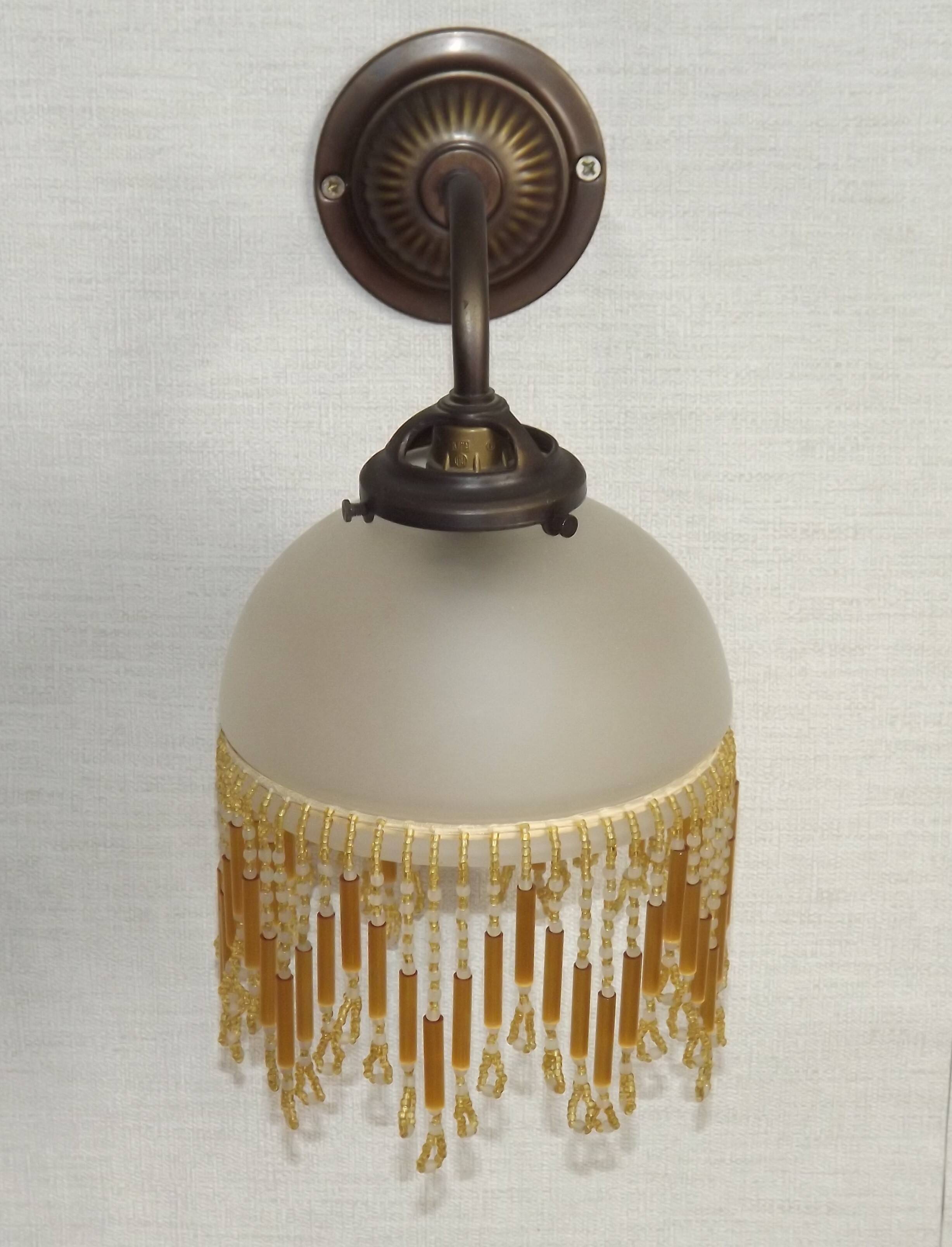 French vintage bronze effect single wall light with opaque beaded glass shade.