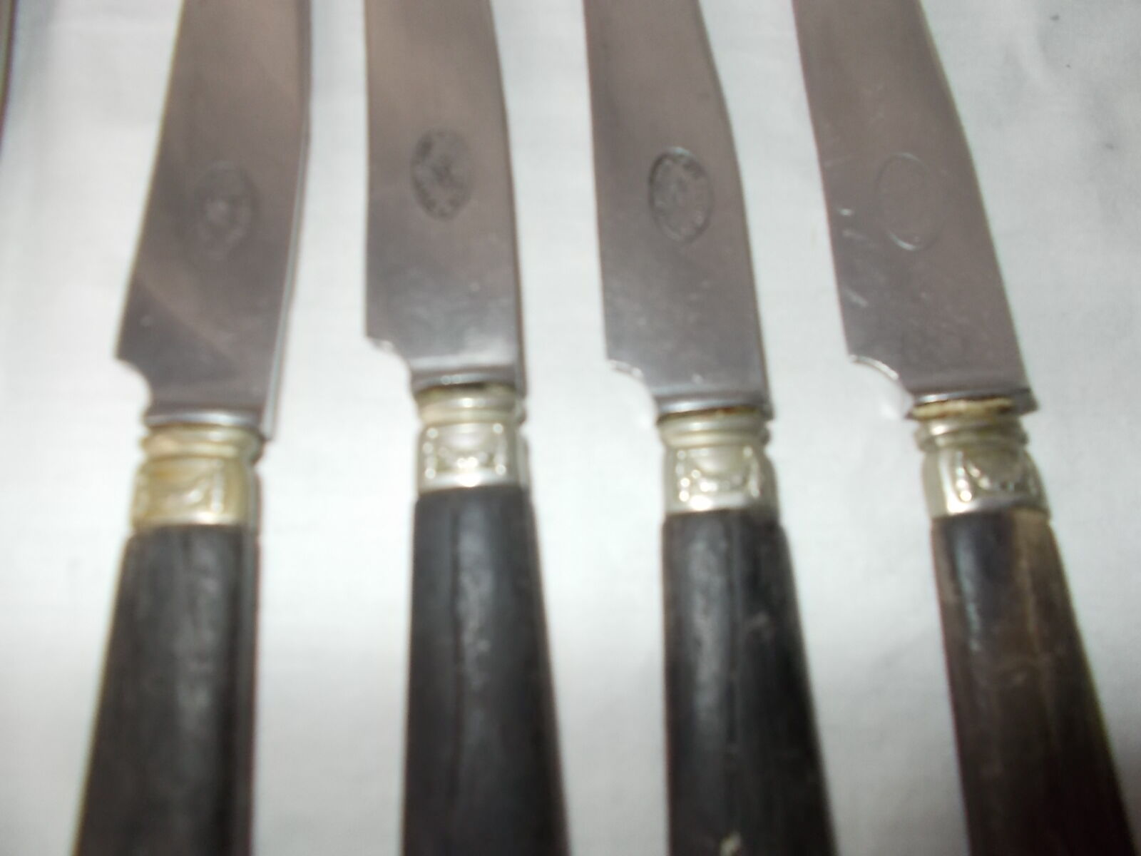 Set of 11 black wooden sleeve knives