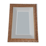 Mirror in gilded stucco wood and beveled glass