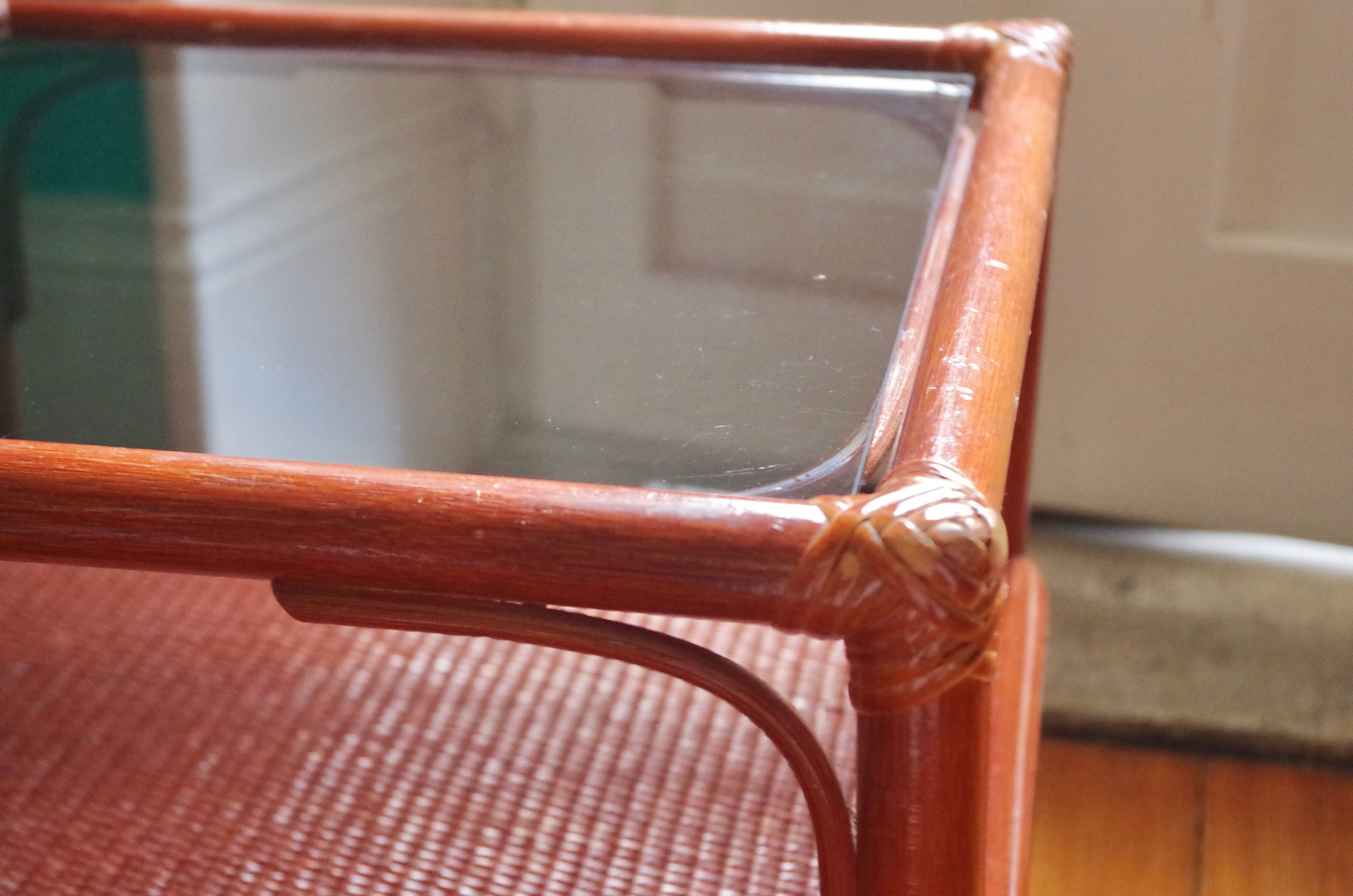 Varnished rattan coffee table and smoked glass top