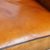 Sheepskin Art Deco design armchair with beautiful wooden details and black piping
