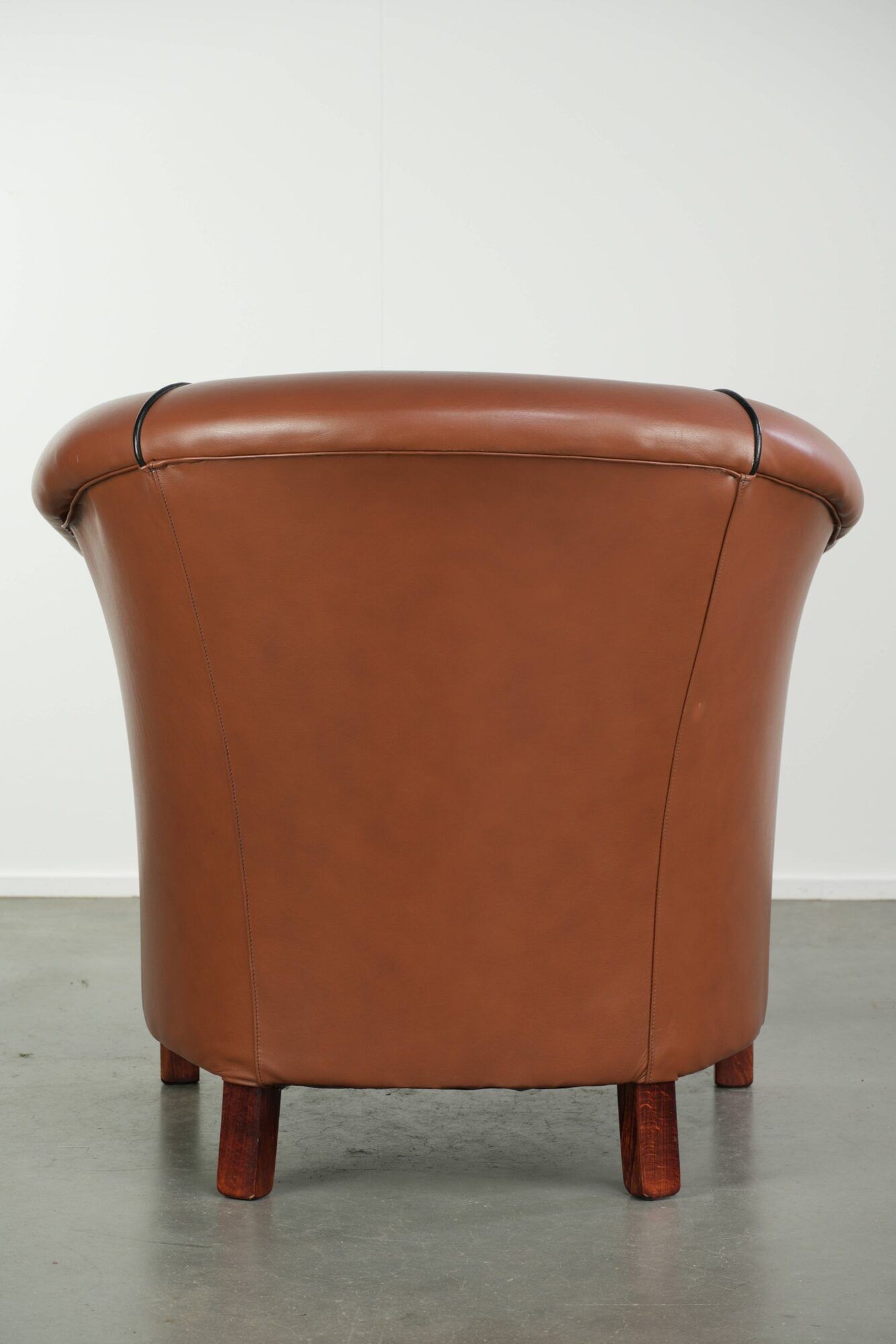 Cowhide club armchair in English style with comfortable seating.