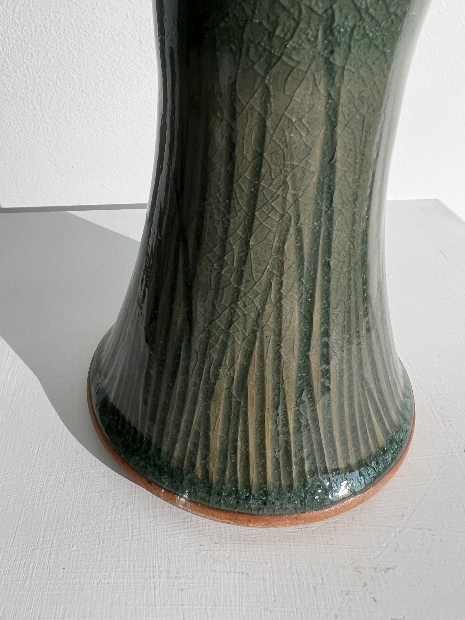 Dark green handcrafted vase with glazed ceramic grass blades