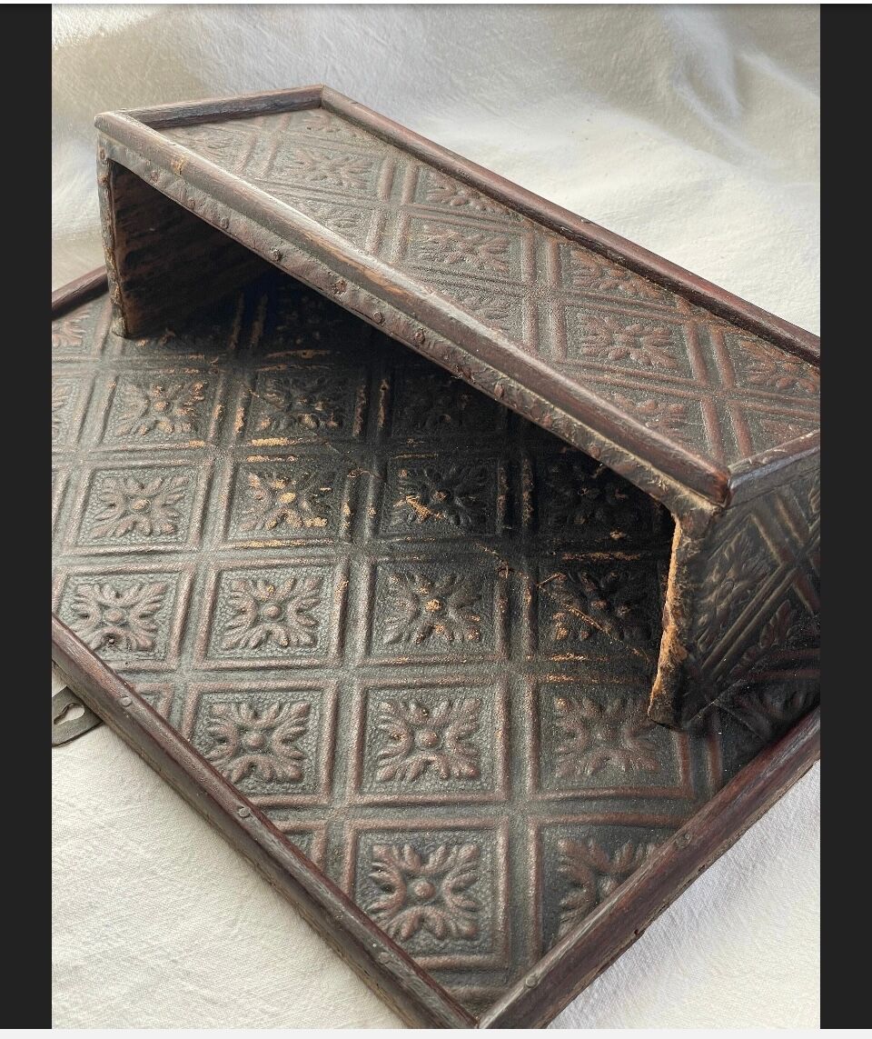 Hammered leather wall mail holder on wood.