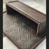 Hammered leather wall mail holder on wood.