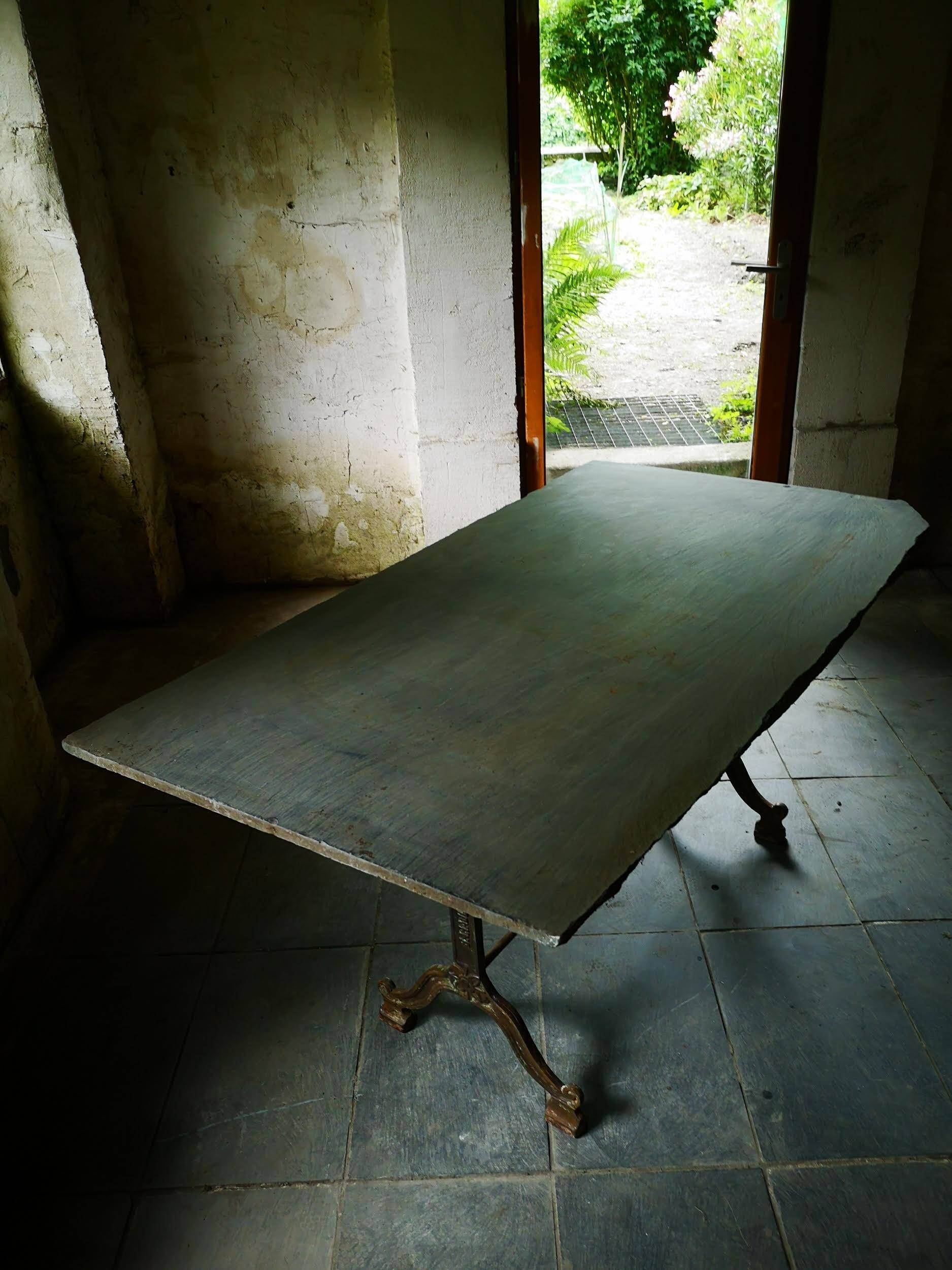 Old bistro table – cast iron legs and natural slate top