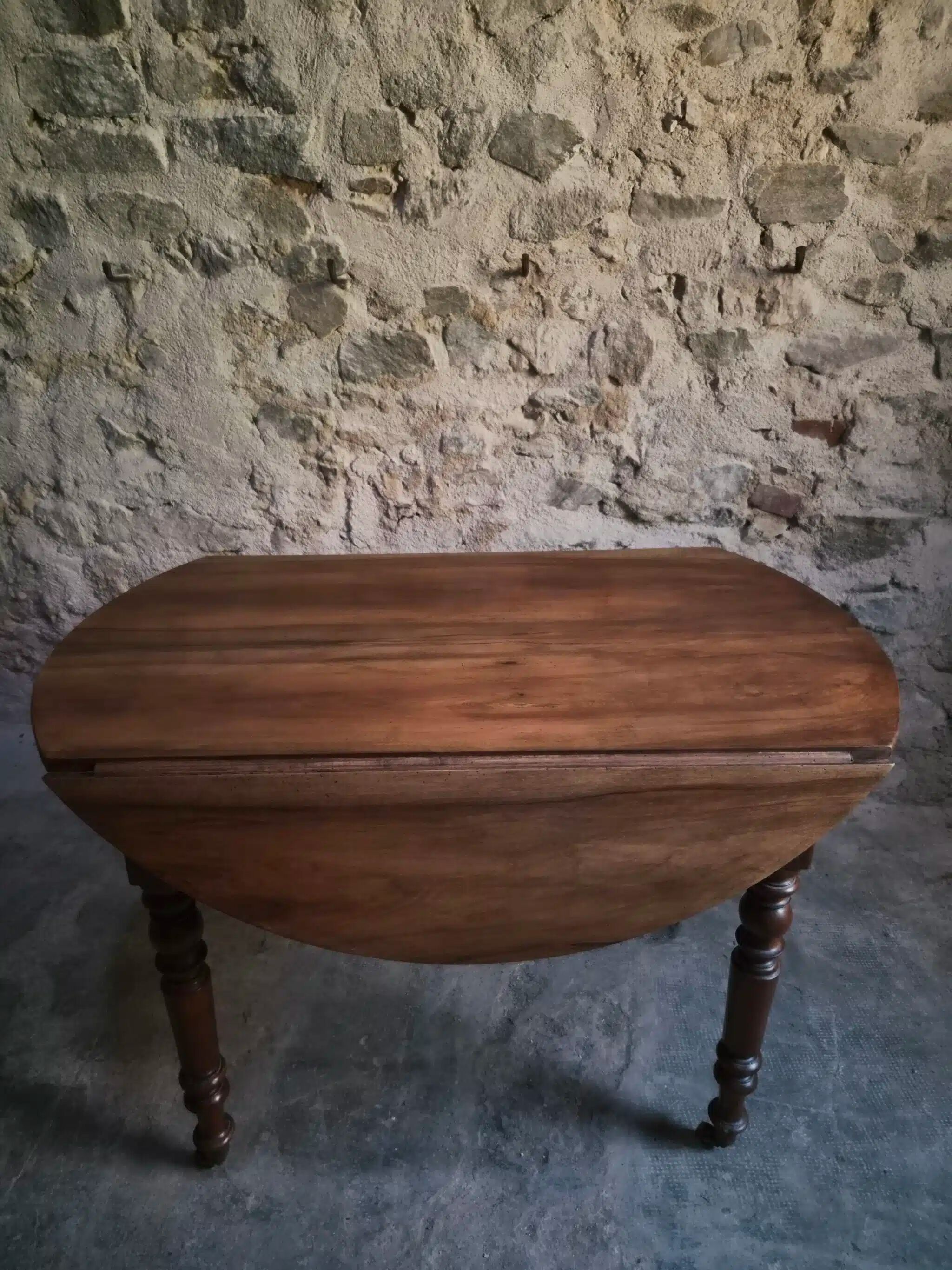 Antique drop-leaf dining table in walnut, France, circa 1900.