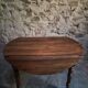 Antique drop-leaf dining table in walnut, France, circa 1900.
