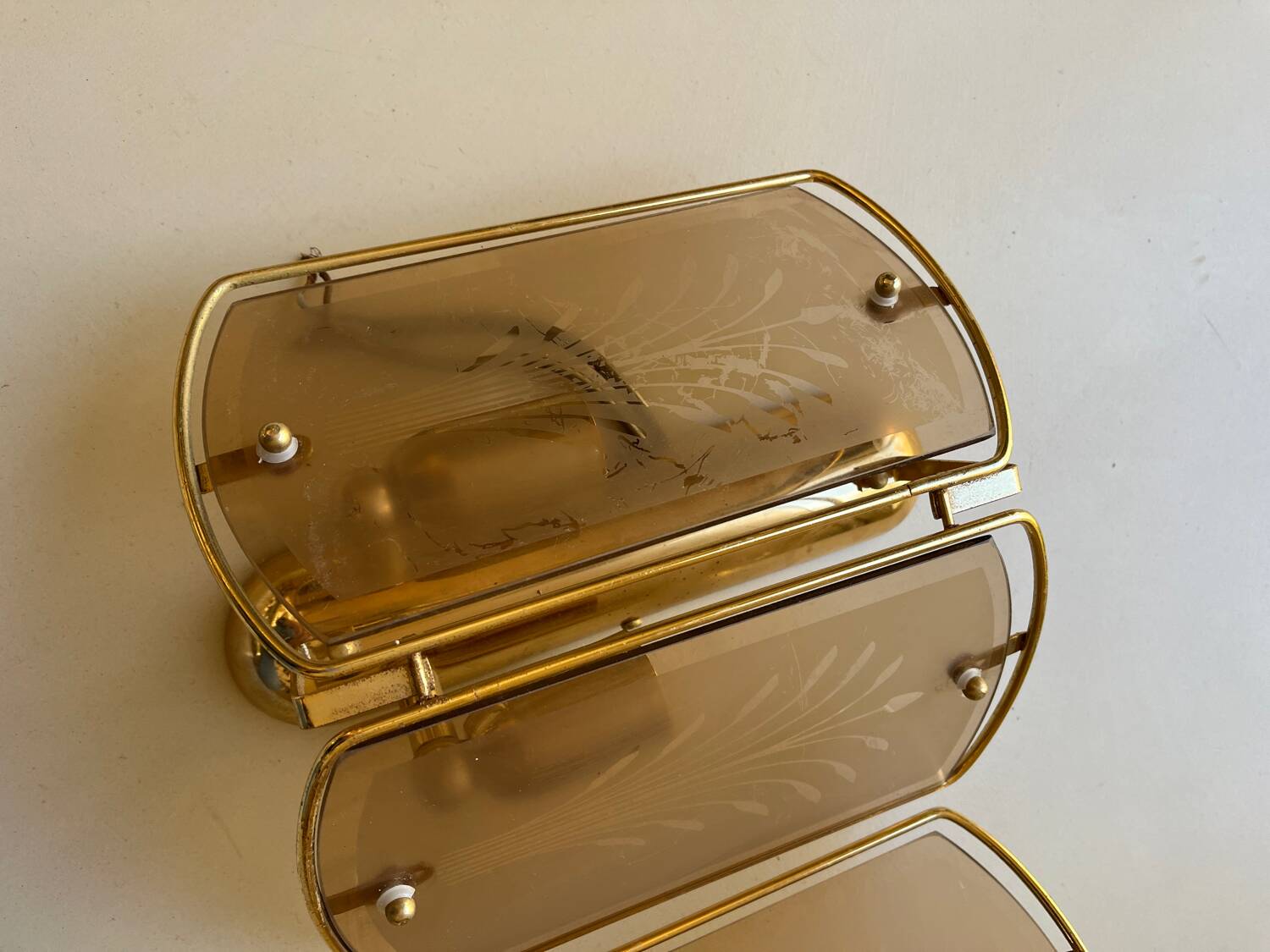 Pair of brass and smoked glass wall lights