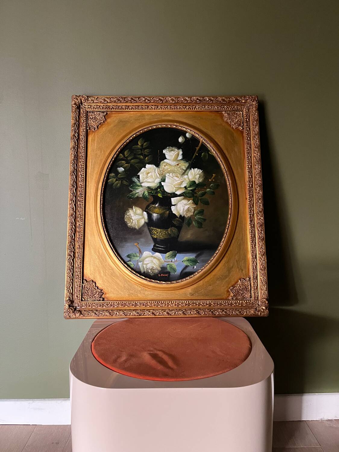 Large still life with white roses in an old gilded oval frame.