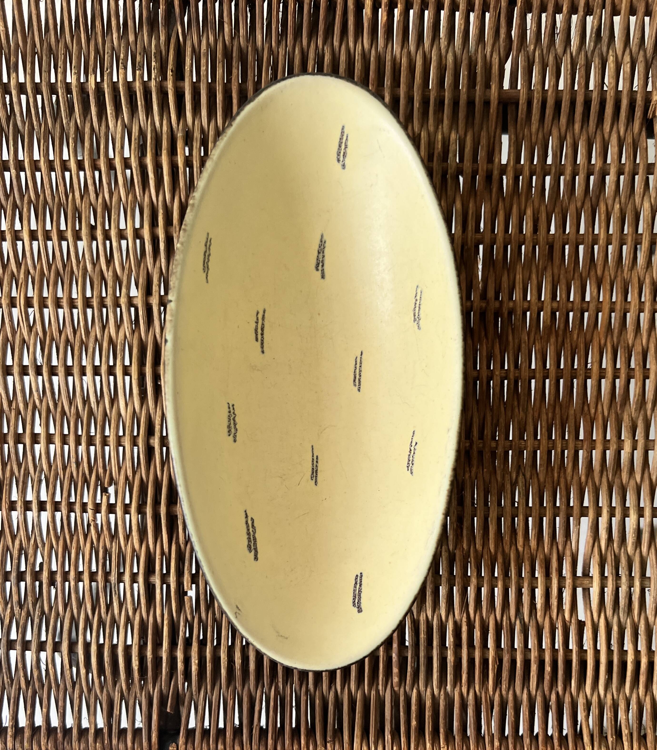 Pale yellow and black ceramic bowl / empty pocket signed by the artist