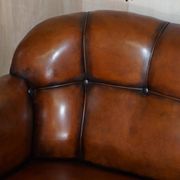 Victorian Chesterfield leather canapé with oak lion claw feet.