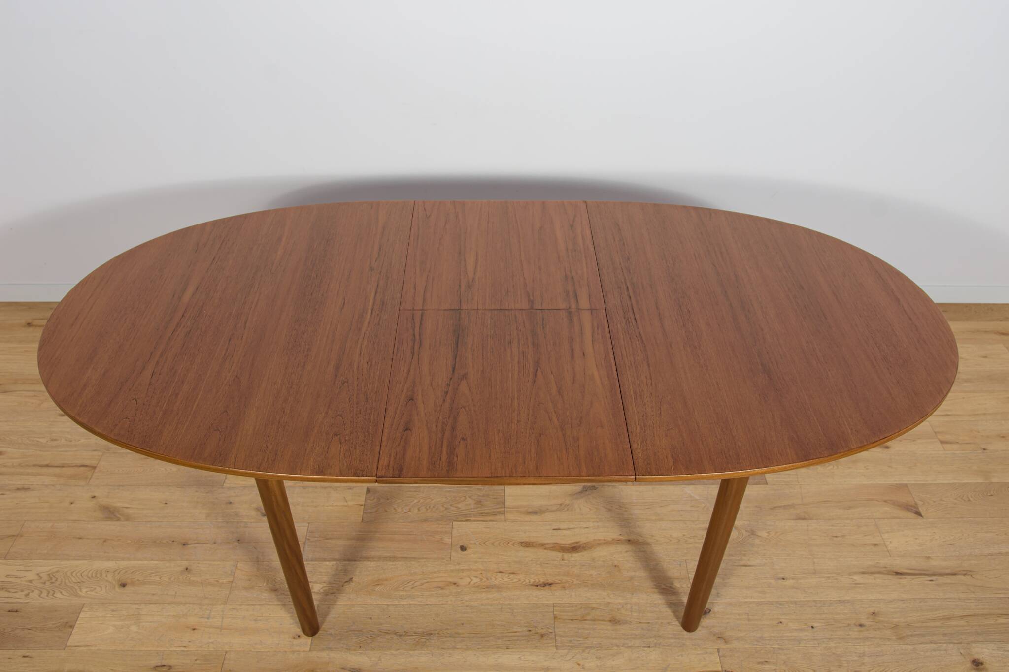 Mid-century extendable oval teak dining table from McIntosh, UK