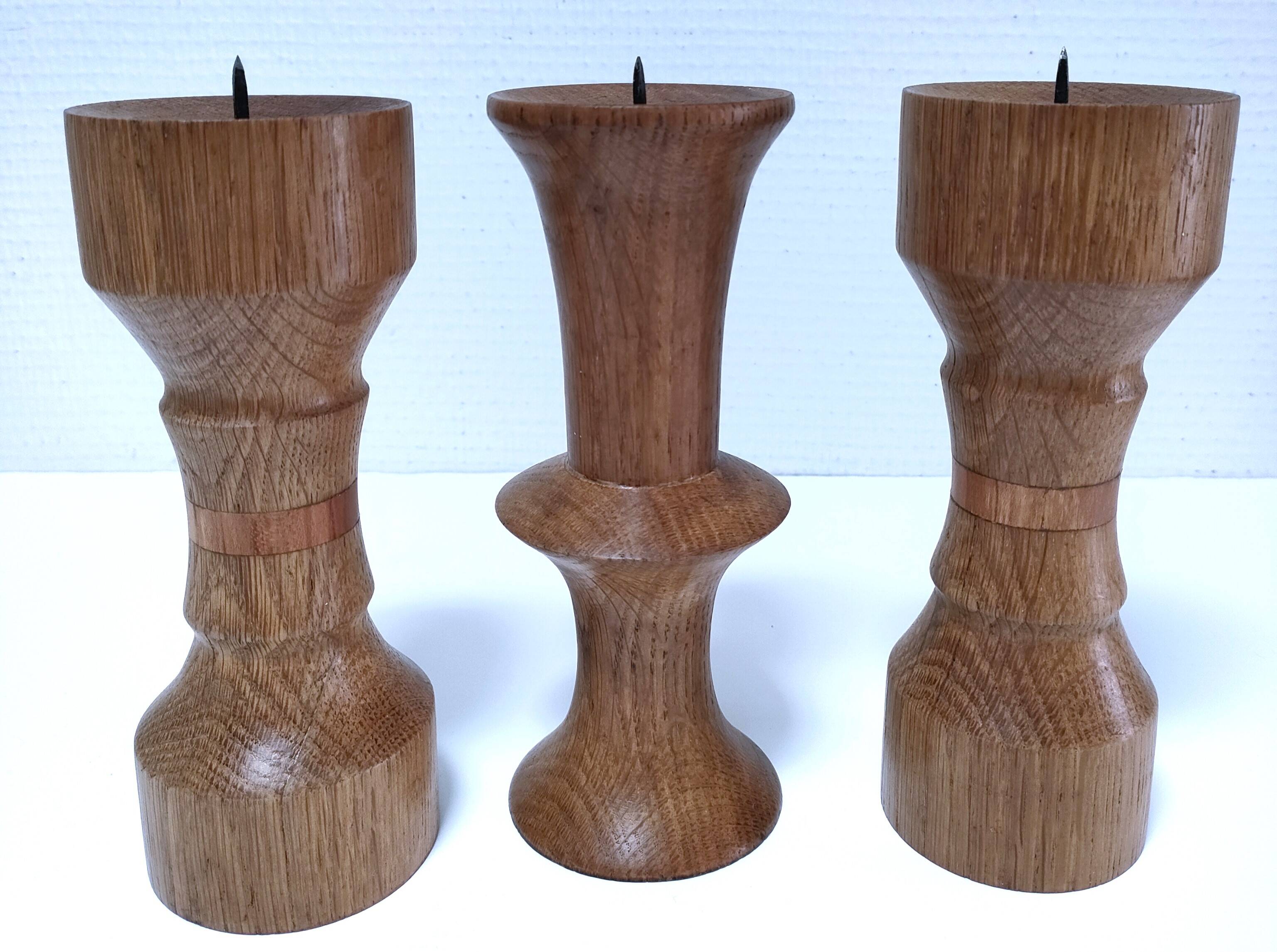 Three vintage patinated solid wood candlesticks