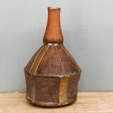 Old terracotta and brass bottle
