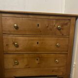 Rustic English pine chest of drawers with porcelain knobs.