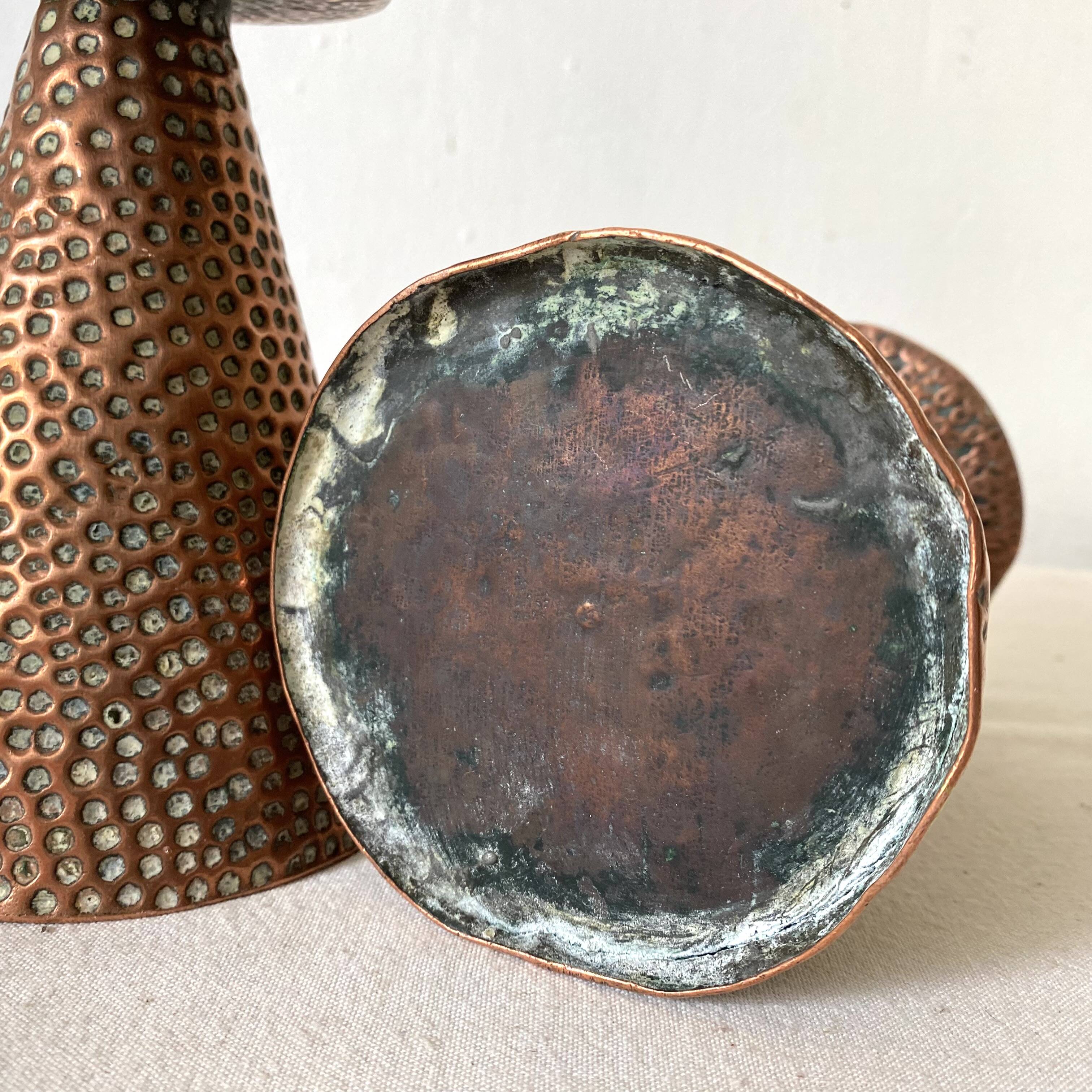 Pair of hammered copper candlesticks from the 1950s