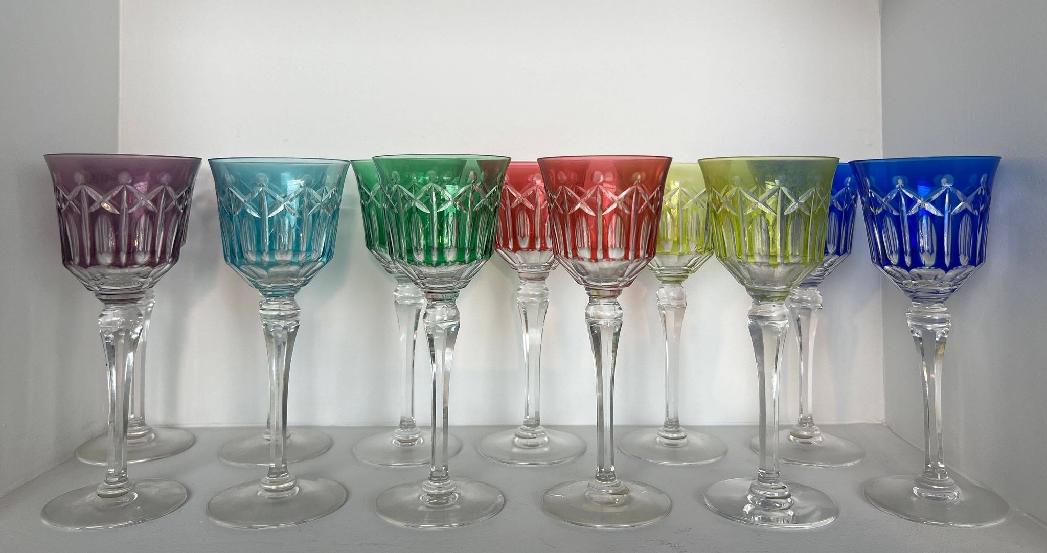 Set of twelve glasses in crystal tinted in different colours and cut with stars.