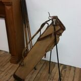 Old golf bag with 5 golf clubs