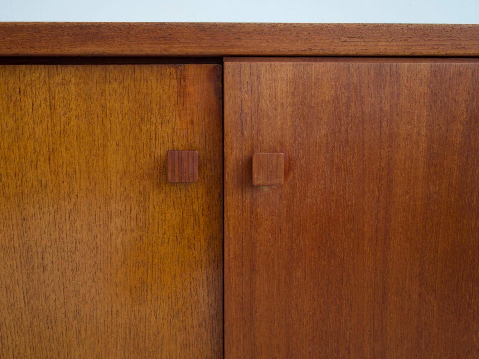 Modern mid-century teak sideboard with brass details.
