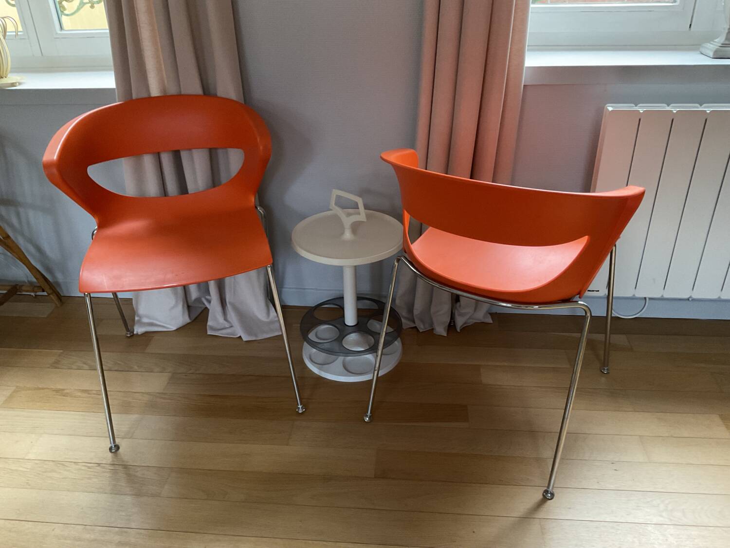 Two orange kicca chairs made in italy tbe