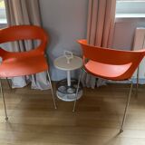 Two orange kicca chairs made in italy tbe