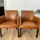 Chair with armrests in aged brown cowhide leather