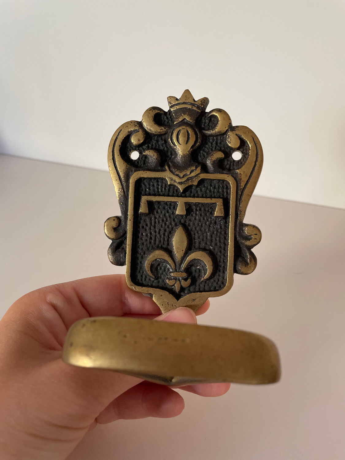 Brass hook fleur-de-lys decoration
