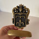 Brass hook fleur-de-lys decoration