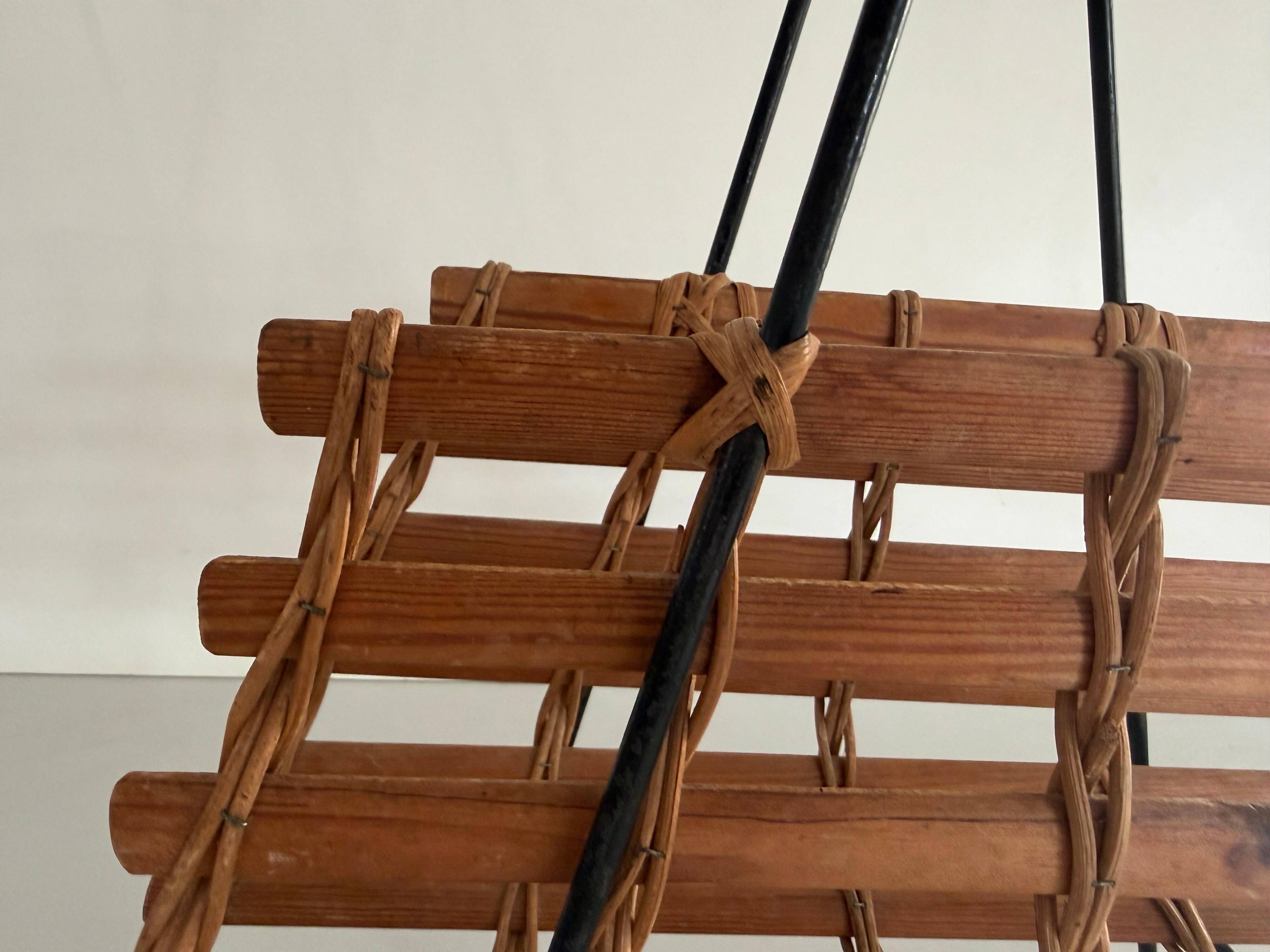Mid-century black metal and wicker magazine rack, 1960, Germany