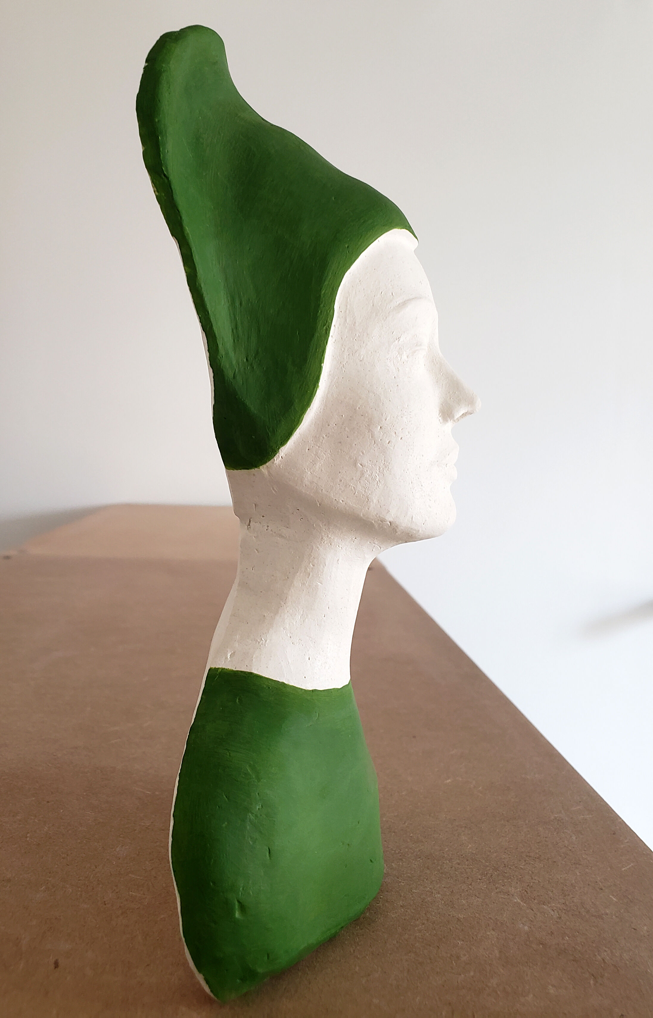 Bust of a woman in green and white plaster