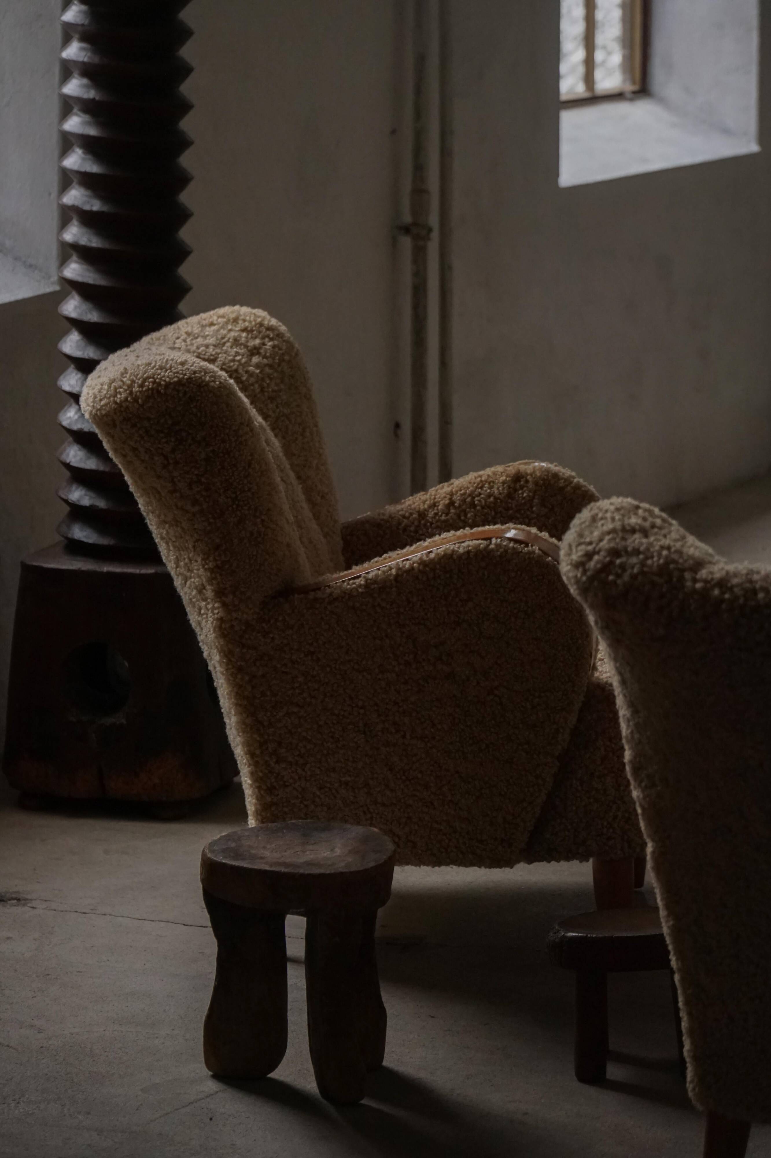 Pair of Danish Art Deco modern lounge chairs in sheepskin with lambswool and elm, 1940s.