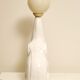 White ceramic table lamp, an elephant holding a lighted ball