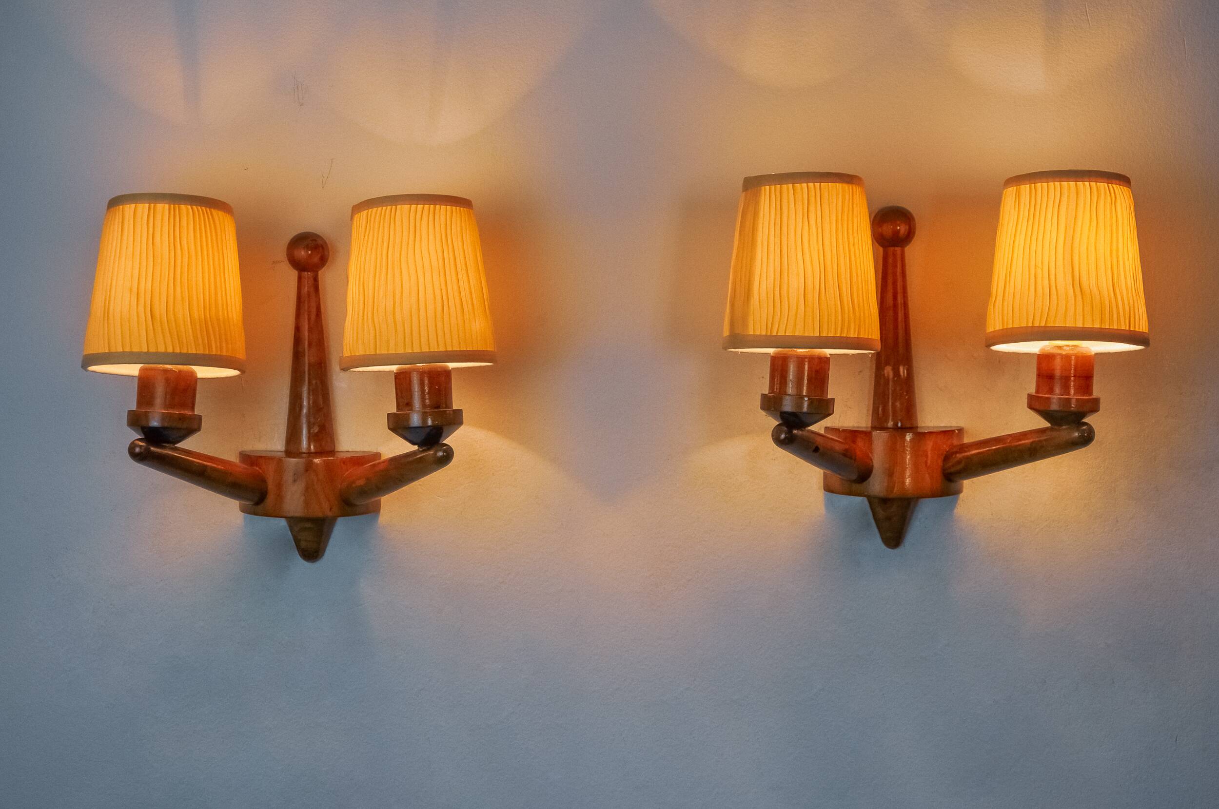 Pair of two-armed art deco "ball" wall lights, carved wood, France, 1960