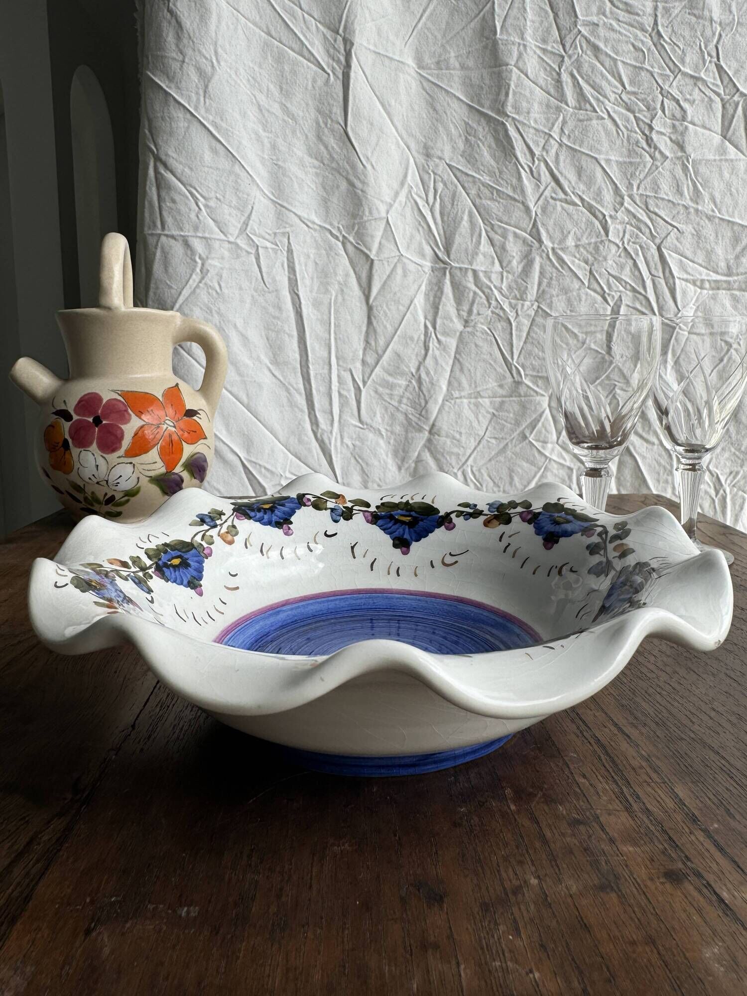Small hand-painted earthenware salad bowl with garland of blue flowers, mark below